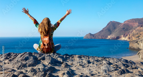 Happy woman with outstretched arms on the beach- Andalusia in Spain- Cabo de gata