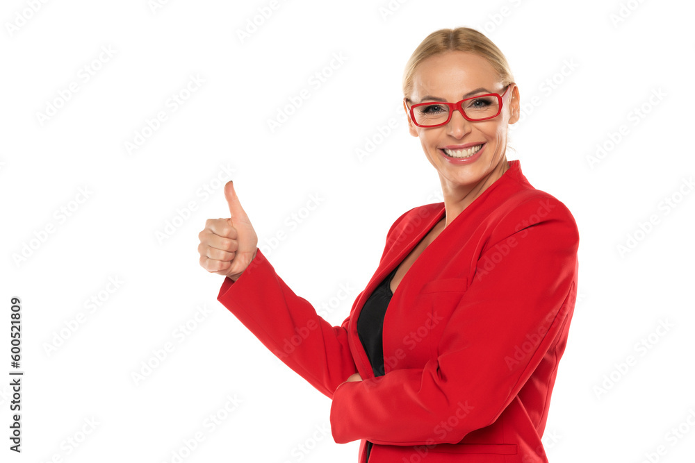 Middle aged senior business woman in red jacket and glasses showing thumbs up on white background Middle aged senior business woman in red jacket and glasses showing thumbs up on white background