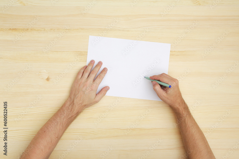 man writing on the paper, top view man writing on the paper, top view