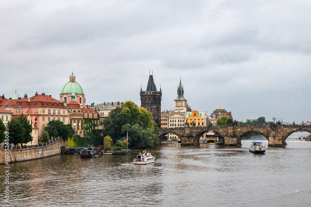 Wide-angle view of the Vltava river and Charles bridge in Prague on a cloudy afternoon, Czech Republic.