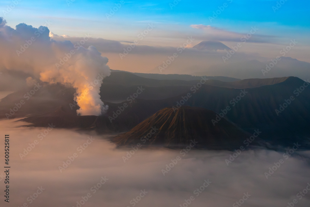 Sunrise over Tengger Semeru National Park wiith a stunning view of two active volcanos: Mount Bromo in the foreground and mount Semeru in the background, East Java, Indonesia.