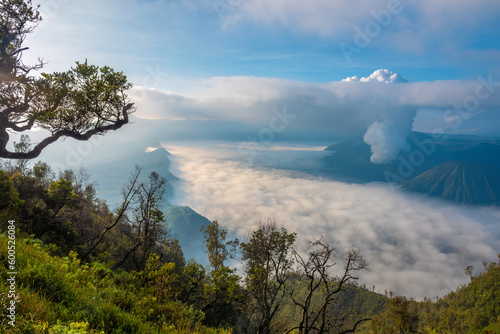 Sunrise over Tengger Semeru National Park wiith a stunning view of two active volcanos: Mount Bromo in the foreground and mount Semeru in the background, East Java, Indonesia. photo