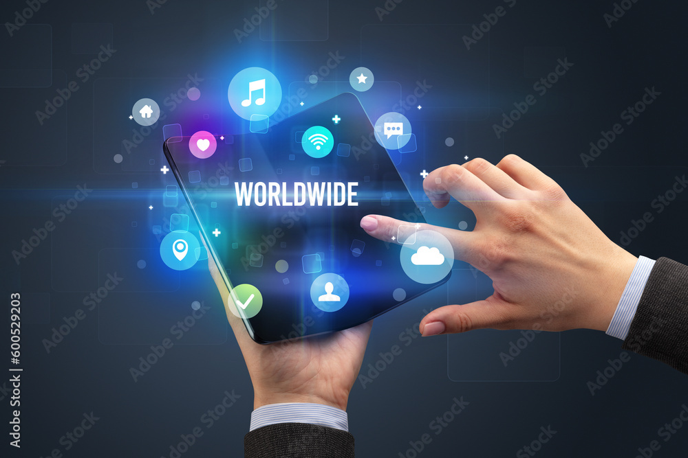 Businessman holding a foldable smartphone Businessman holding a foldable smartphone