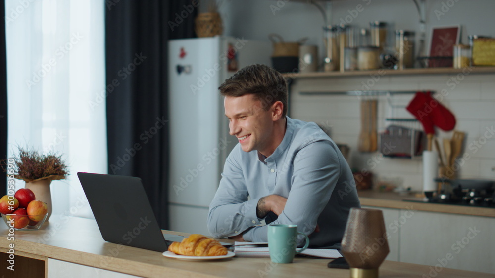 Guy speaking video call with girlfriend sitting at kitchen. Man using web chat.