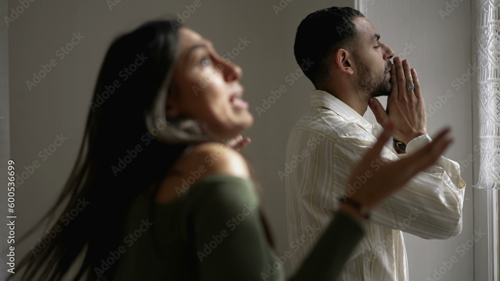 Silent Suffering_ Boyfriend Endures Girlfriend_s Mockery as She Gestures in backgrounf in Tense Home discussion. Couple fighting in crisis Silent Suffering_ Boyfriend Endures Girlfriend_s Mockery as She Gestures in backgrounf in Tense Home discussion. Couple fighting in crisis