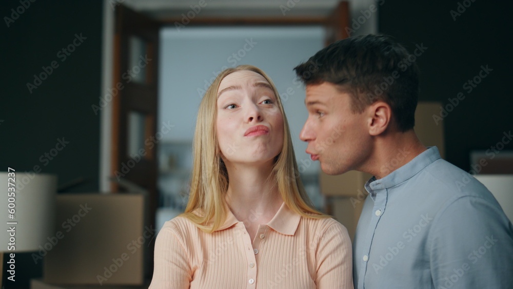 Abusive man scolding woman in new home close up. Young unhappy couple arguing. Abusive man scolding woman in new home close up. Young unhappy couple arguing.