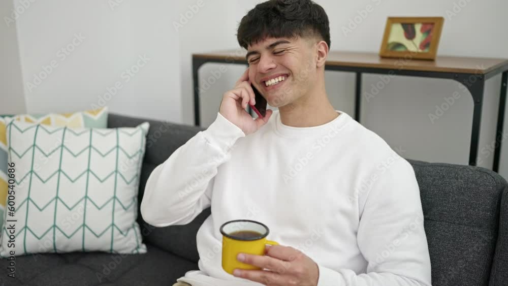 Young hispanic man talking on smartphone drinking coffee at home Young hispanic man talking on smartphone drinking coffee at home