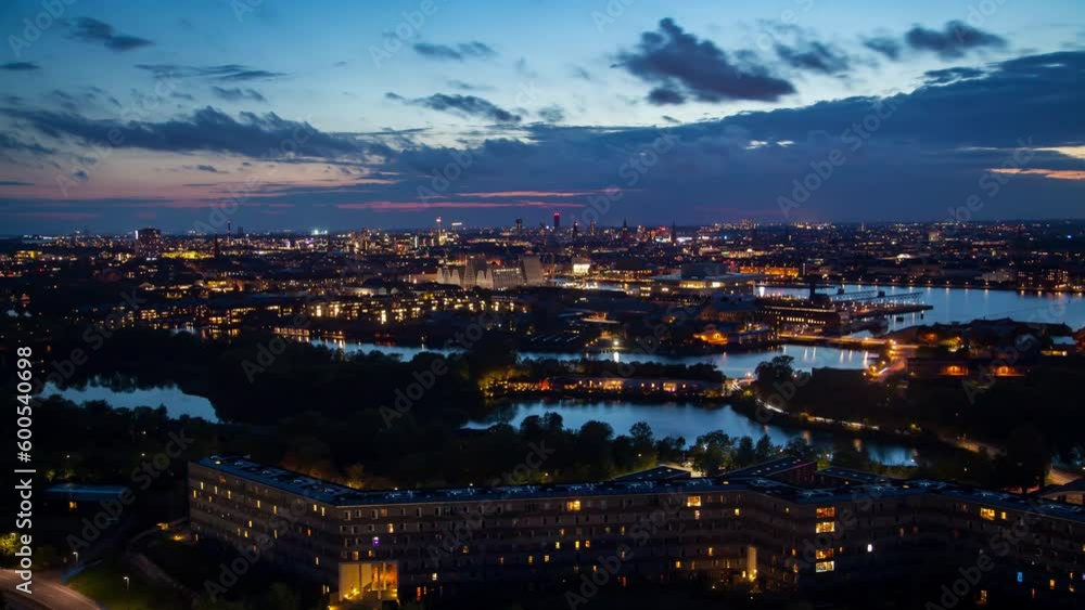 A stunning timelapse of the Copenhagen, Denmark skyline featuring a mesmerizing sunset, cityscape, river, and autumn atmosphere. Perfect for urban, travel, or background use. A stunning timelapse of the Copenhagen, Denmark skyline featuring a mesmerizing sunset, cityscape, river, and autumn atmosphere. Perfect for urban, travel, or background use.