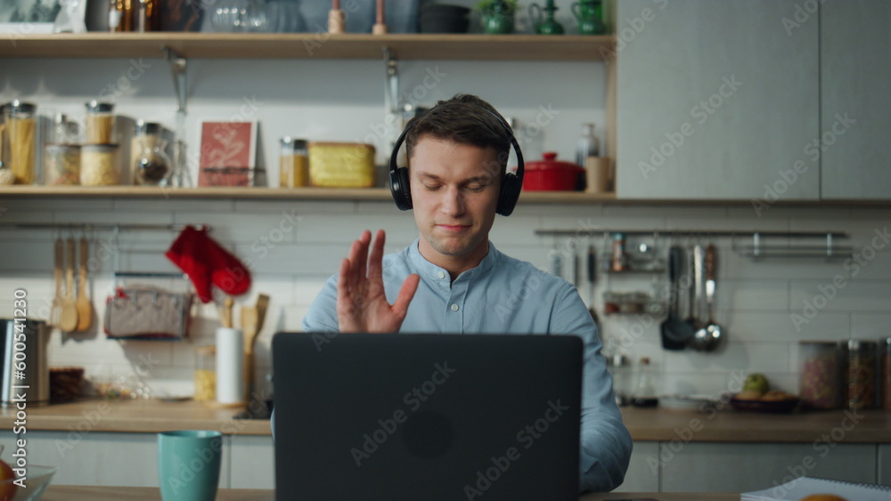 Remote worker saying goodbye to colleagues after video conference close ...