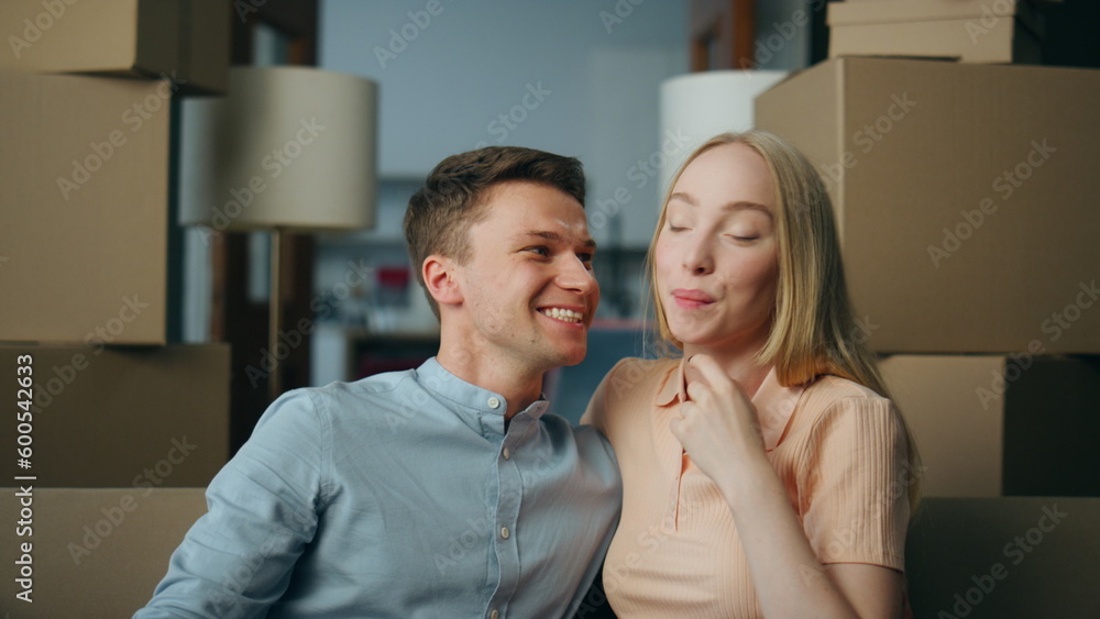 Young family happy moving in new apartment sitting surrounded boxes close up Young family happy moving in new apartment sitting surrounded boxes close up