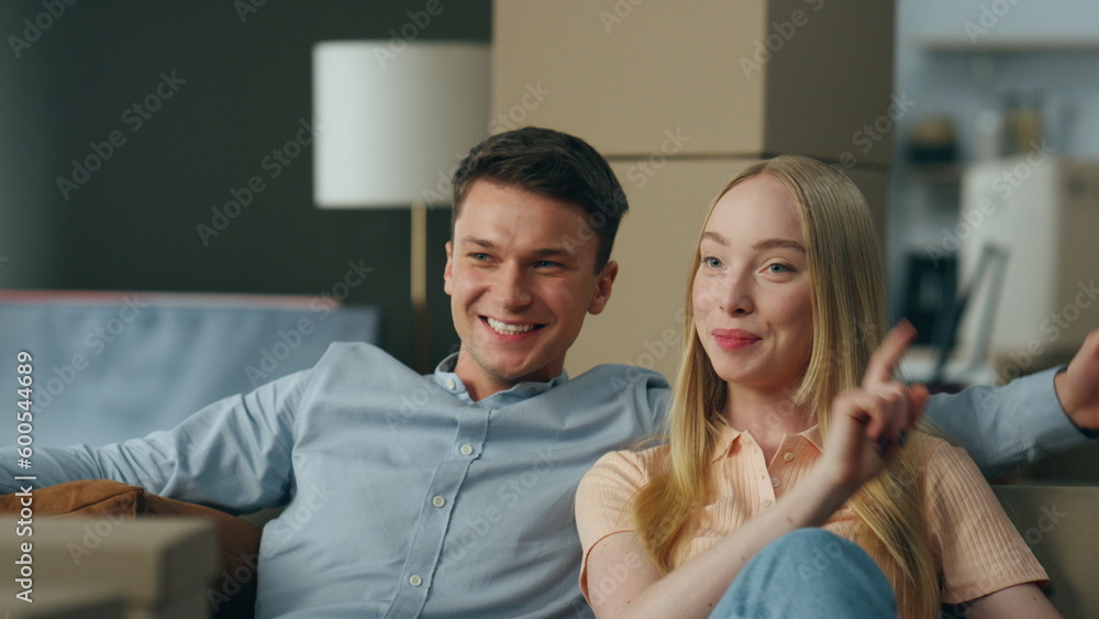 Spouses planning interior new home sitting on sofa close up. Pair enjoy moving. Spouses planning interior new home sitting on sofa close up. Pair enjoy moving.