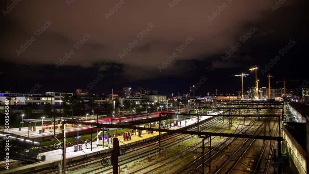 Stunning timelapse of downtown Copenhagen with train traffic, busy metro station, and city skyline on a cloudy autumn night. Stunning timelapse of downtown Copenhagen with train traffic, busy metro station, and city skyline on a cloudy autumn night.