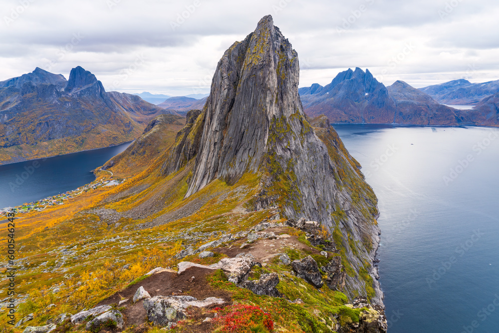 Obraz premium View from the ridge between Hesten mountain towards Segla mountain with Fjordgard in the deep on the left side and the slopes covered in autumn trees, Troms og Finnmark, Norway