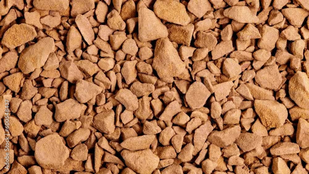 Instant coffee, small granules, bunch in bulk rotating, turning, close-up macro, top view
Instant coffee, small granules, bunch in bulk rotating, turning, close-up macro, top view