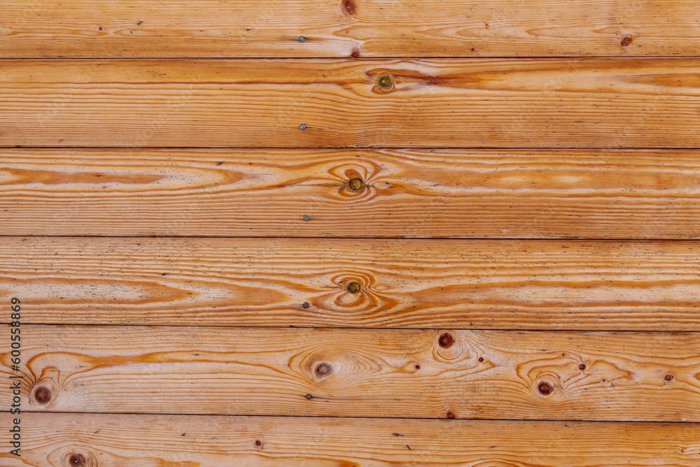 Abstract textured wooden background. Wall of house from brown wooden boards. Copy space for your text and decorations. Natural construction materials theme. Abstract textured wooden background. Wall of house from brown wooden boards. Copy space for your text and decorations. Natural construction materials theme.