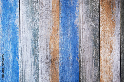 wooden board with bright blue and beige paint and cracks. vertical lines. rough surface texture