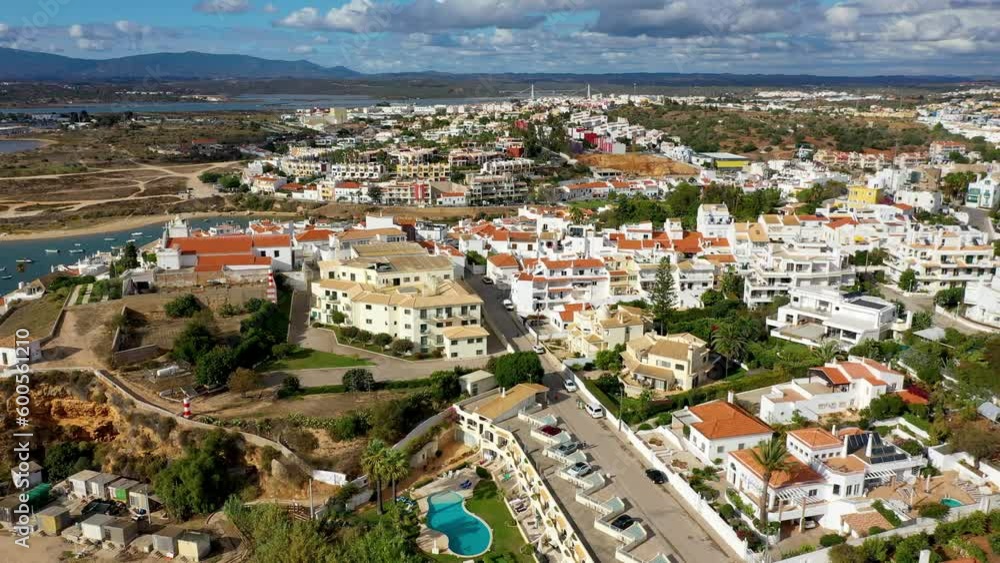 View of Ferragudo village in Algarve, Portugal. Old sea town of Ferragudo. View of Ferragudo from the air. Ferragudo is a beautiful coastal village in Algarve, Portugal, Europe. View of Ferragudo village in Algarve, Portugal. Old sea town of Ferragudo. View of Ferragudo from the air. Ferragudo is a beautiful coastal village in Algarve, Portugal, Europe.