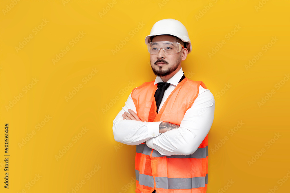asian foreman in uniform stands with arms crossed on yellow isolated background, korean civil engineer in hard hat asian foreman in uniform stands with arms crossed on yellow isolated background, korean civil engineer in hard hat