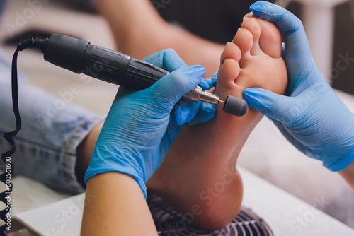 Process pedicure close-up, polishing feet, unrecognizable people. blurred face.