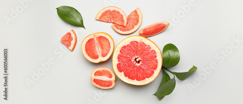 Ripe cut grapefruit on light background, top view