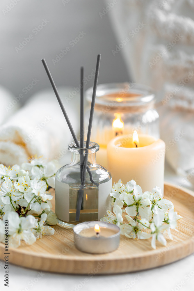 Home comfort, coziness, aromatherapy. Cozy interior with knitting, burning candles and aroma perfume diffuser in the living room. Fresh spring blossom fragrance, apple cherry flowers. Home comfort, coziness, aromatherapy. Cozy interior with knitting, burning candles and aroma perfume diffuser in the living room. Fresh spring blossom fragrance, apple cherry flowers.