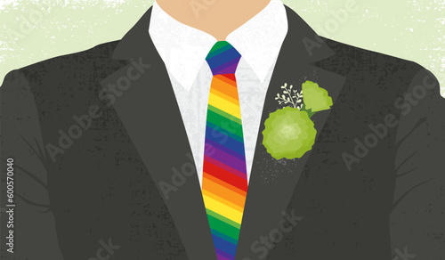 A mans suit with rainbow tie and green carnation pinned to the lapel. The green carnation was a symbol for gay men in the late 1800's
