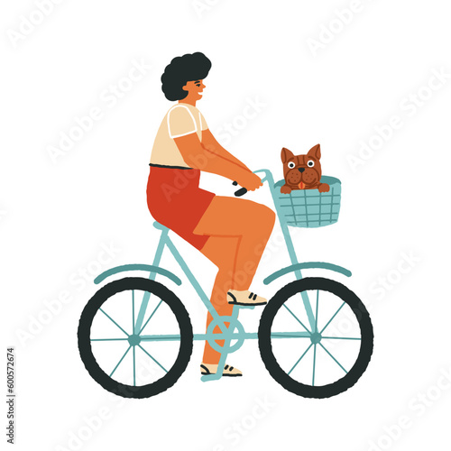 Hispanic man, the woman rides a bike, her French bulldog puppy with big eyes sitting in the basket. Riding with a pet.