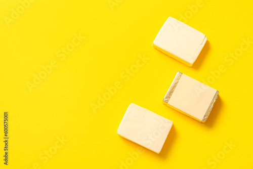 Processed cheese on yellow background