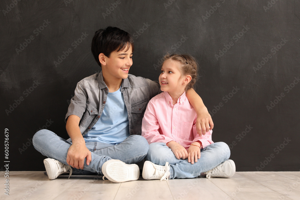 Little children hugging near blackboard Little children hugging near blackboard