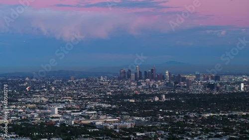 Wallpaper Mural Aerial Panning Shot Of Skyscrapers In City Near Mountains Against Cloudy Sky, Drone Flying Over Cityscape At Dusk - Los Angeles, California Torontodigital.ca