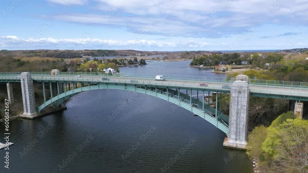 Large bridge with cars over the water leading to an island Large bridge with cars over the water leading to an island