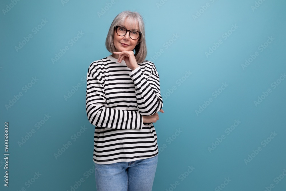 portrait of a pleasant woman 60s in a fashionable image on a bright studio background portrait of a pleasant woman 60s in a fashionable image on a bright studio background