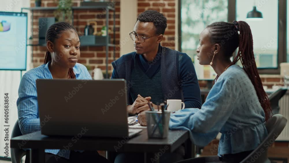 Office workers planning business project, talking about solutions to increase company profit. Modern partners collaborating to create research presentation with annual reports and data analytics.