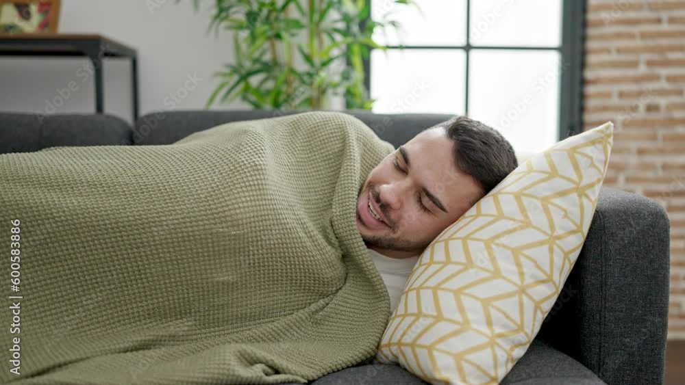 Young hispanic man lying on sofa sleeping at home Young hispanic man lying on sofa sleeping at home