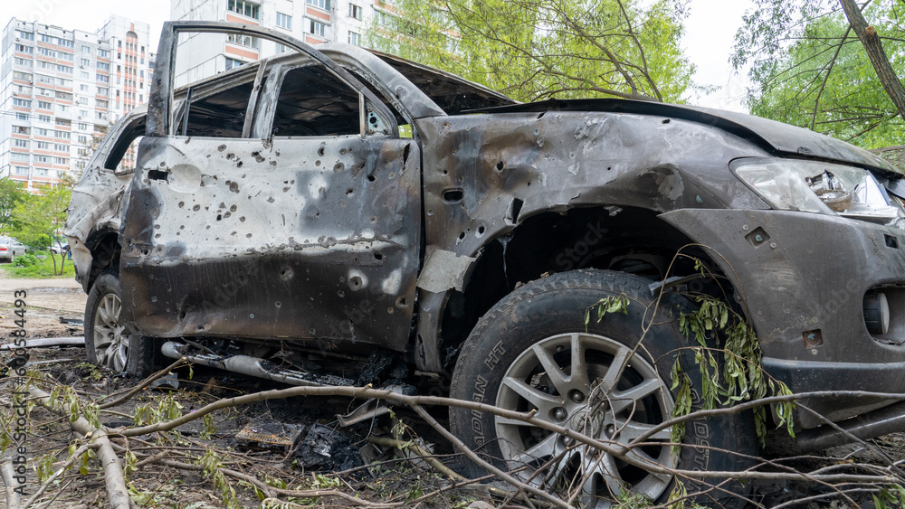Burnt car with shrapnel holes at the site of the explosion after Russia's biggest missile attack on Kiev, the concept of Russia's war against Ukraine Burnt car with shrapnel holes at the site of the explosion after Russia's biggest missile attack on Kiev, the concept of Russia's war against Ukraine