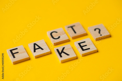 fact or fake words with a question on a yellow background.