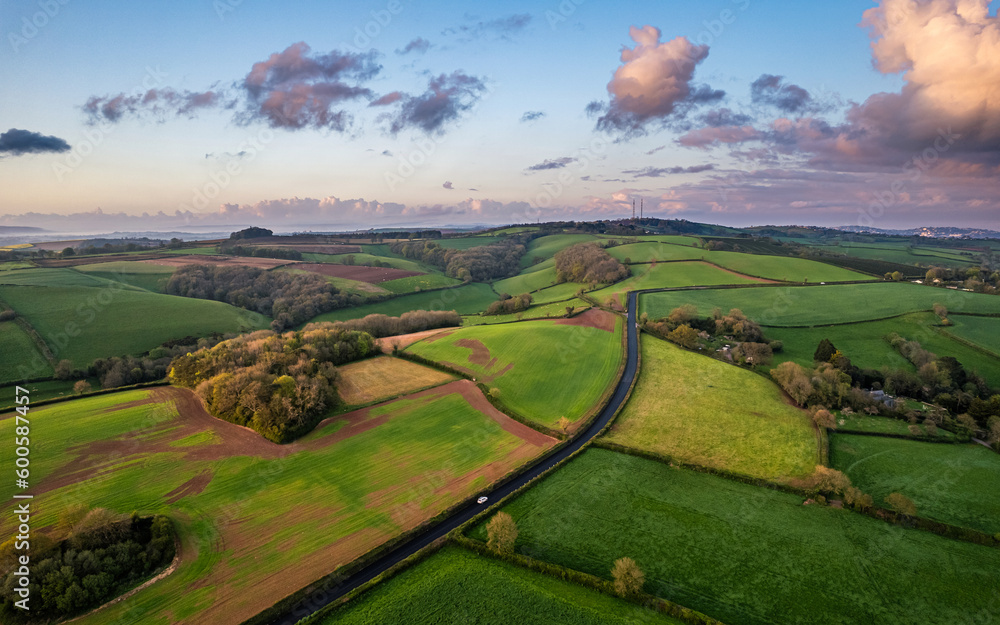 Sunset over Fields and Farmlands in spring from a drone, Devon, England,  Europe