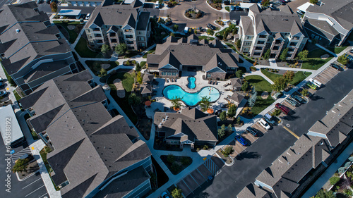 Aerial view of an apartment complex with a pool and clubhouse