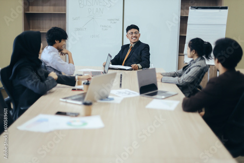 Successful businessman presenting analytical report to the team in the modern office