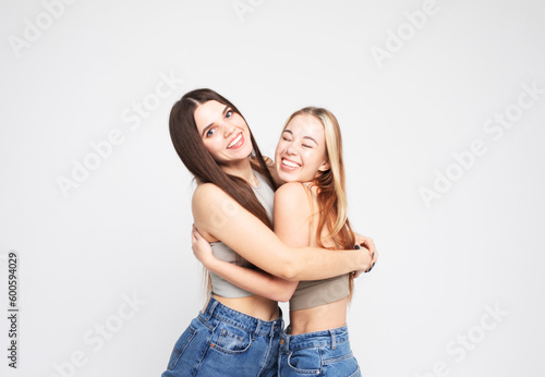 lifestyle and people concept: Two young female friends standing together and having fun.