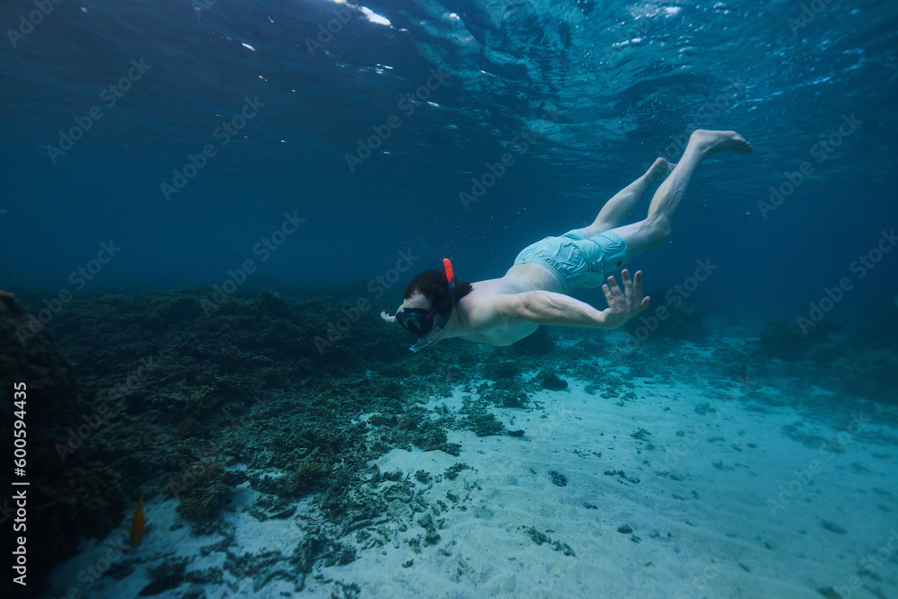 man snorkeling in the ocean underwater photo