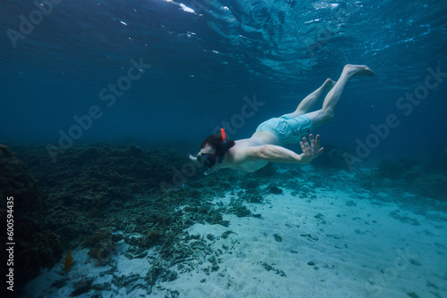 man snorkeling in the ocean underwater photo