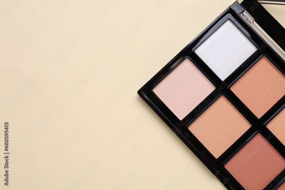 Colorful contouring palette on beige background, top view with space for text. Professional cosmetic product Colorful contouring palette on beige background, top view with space for text. Professional cosmetic product