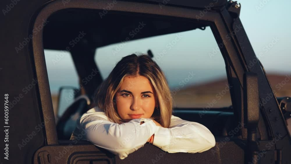 Headshot portrait of young woman sitting on passenger seat of car looking at the camera enjoying summer outdoors. Beautiful blonde female adult.
Headshot portrait of young woman sitting on passenger seat of car looking at the camera enjoying summer outdoors. Beautiful blonde female adult.