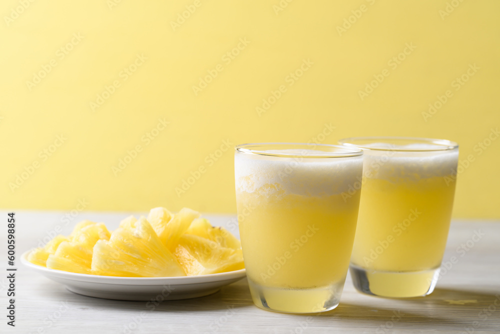 Pineapple smoothie in glass with sliced pineapple fruit, Tropical summer drink Pineapple smoothie in glass with sliced pineapple fruit, Tropical summer drink