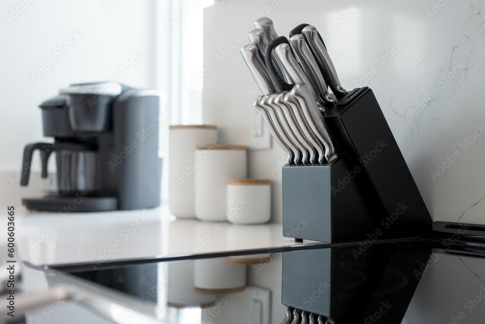 Knife block and kitchen utensils. Knives in kitchen setting. Knife block and kitchen utensils. Knives in kitchen setting.