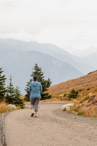 Young caucasian woman hikes at Hurricane Ridge in Olympic National Park in Washington State.