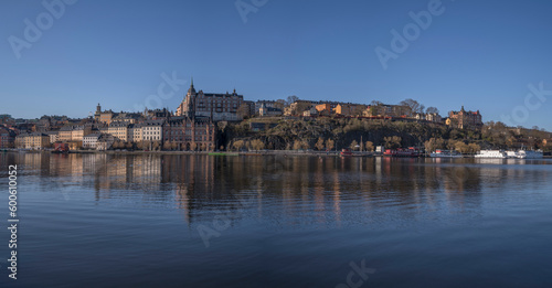 Morning view at the bay Riddarviksfjärden, old stone 1700s houses on the hill Mariabrget in the district Södermalm, a sunny early tranquil summer day in Stockholm