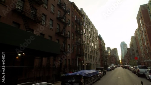 Pov Tilt Up Shot Of Vehicles On Street Amidst Buildings In City Against Sky - New York City, New York photo