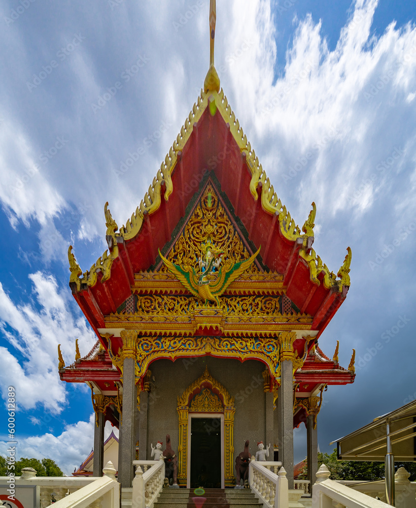 Beautiful Wat Buddhist temple in Phuket Karon Thailand. Decorated in beautiful ornate colours of Gold blue green red and White. Sunset Sunrise lovely sky and cloud colours Beautiful Wat Buddhist temple in Phuket Karon Thailand. Decorated in beautiful ornate colours of Gold blue green red and White. Sunset Sunrise lovely sky and cloud colours